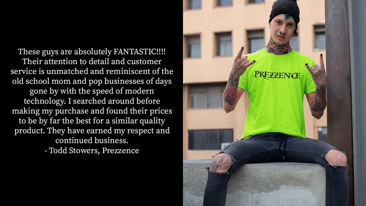 Man wearing a Prezzence-branded tshirt sitting on a wall